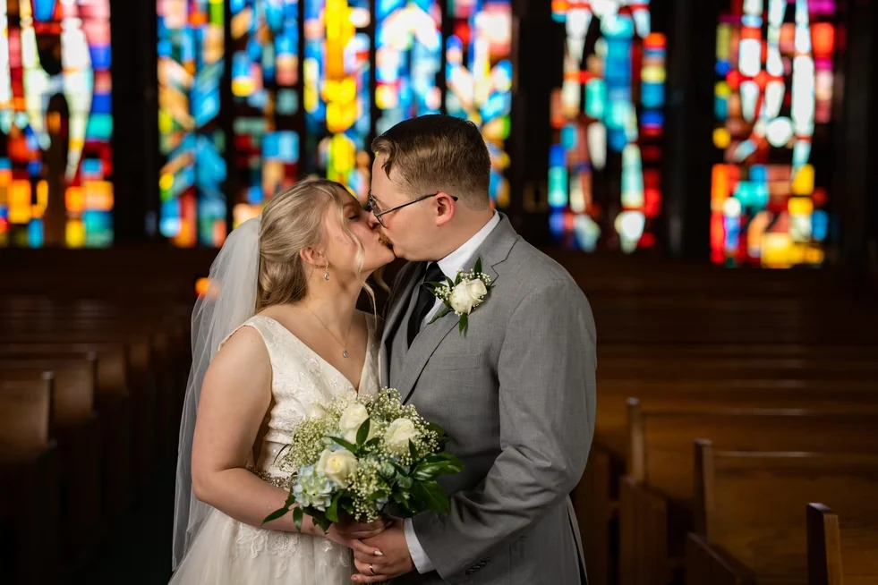 Newlyweds kissing inside a church